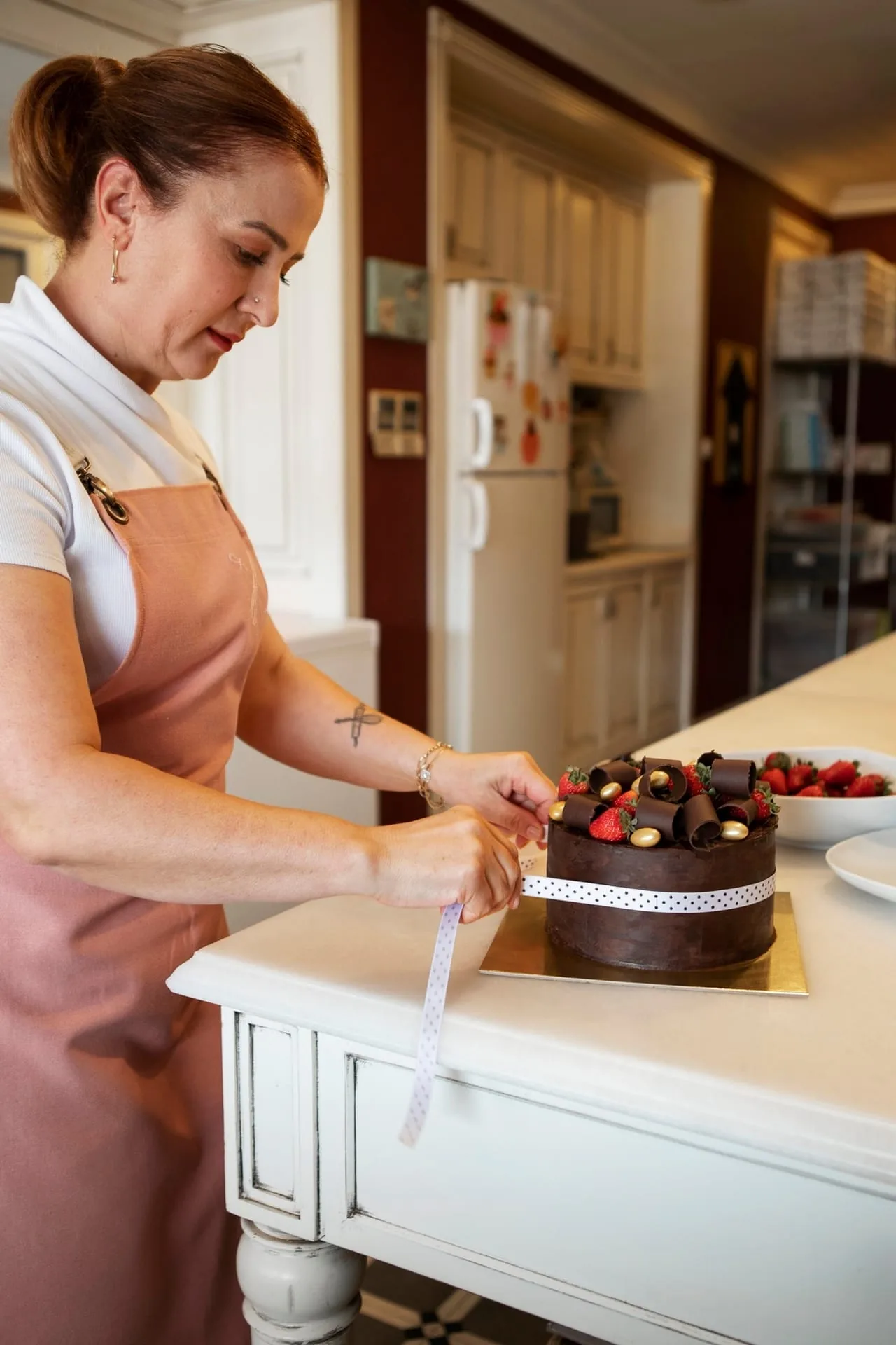 A spread of handcrafted cakes and desserts arranged on a soft linen surface